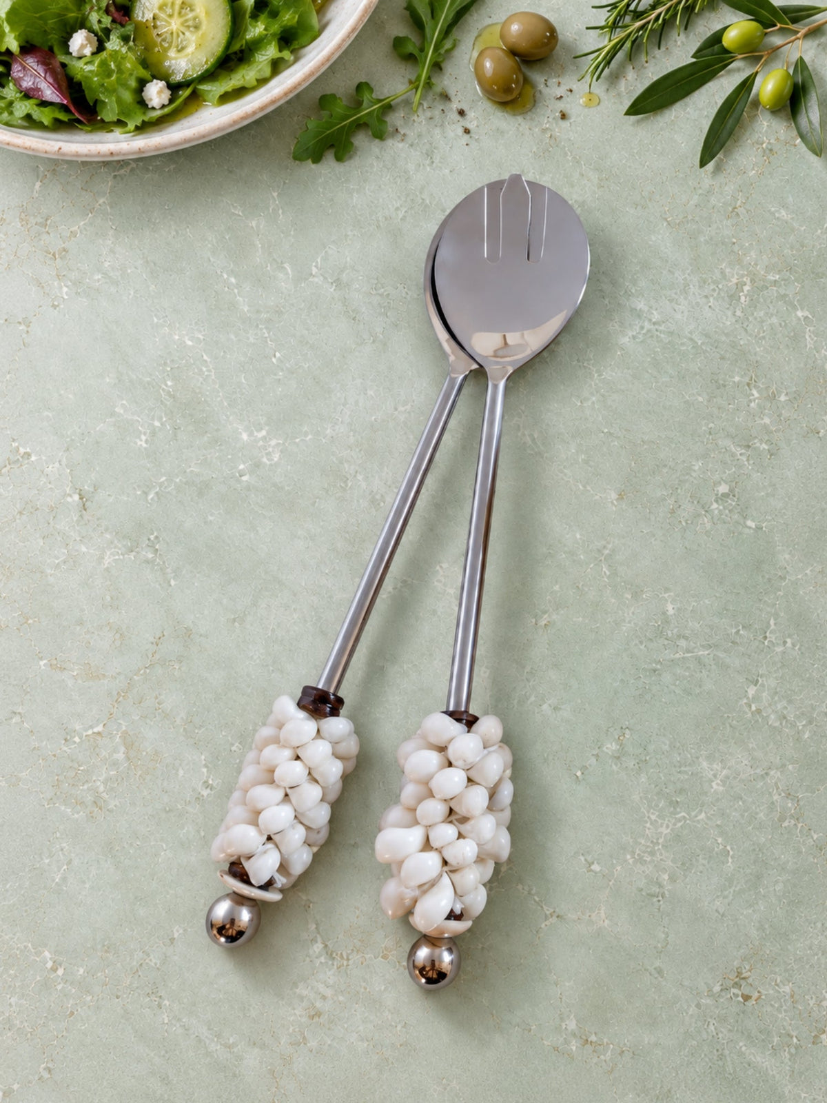 Salad serving spoon and fork with white shell-decorated handles
