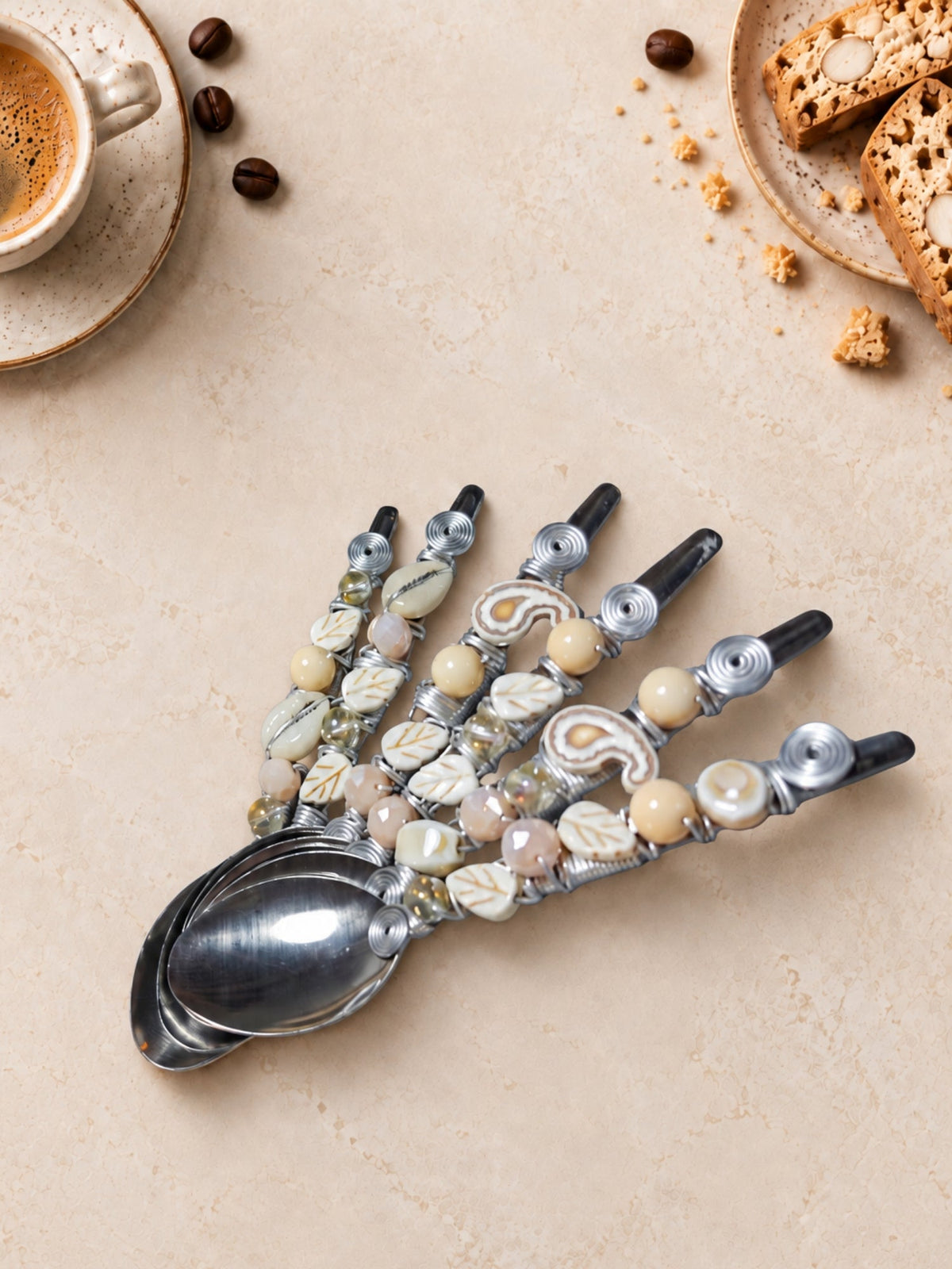Six coffee spoons with cream, pale pink and patterned beaded handles