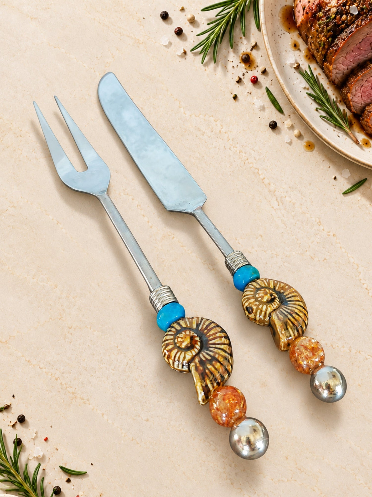 Carving knife and fork with blue beads and gold-coloured spiral decorations on the handles