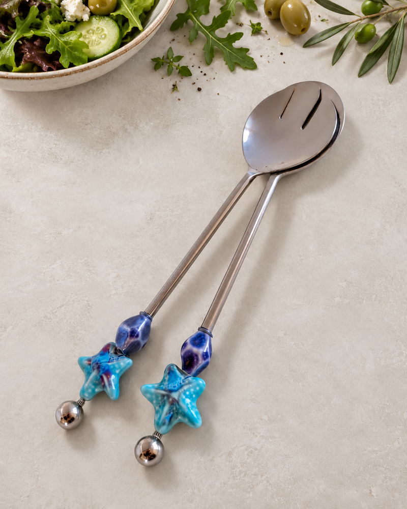 Decorative salad serving set with silver-coloured utensils, blue and purple glass beads, turquoise starfish details and polished silver end beads, The Kadun.