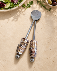 Silver-coloured salad serving set featuring patterned shell handles in cream, brown and black, with polished silver end beads, designed as The Esti.