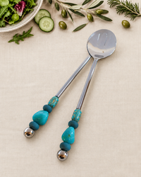 The Bijali decorative salad serving set with a silver-coloured spoon and slotted server, turquoise and blue beads, silver detailing and polished silver end beads.
