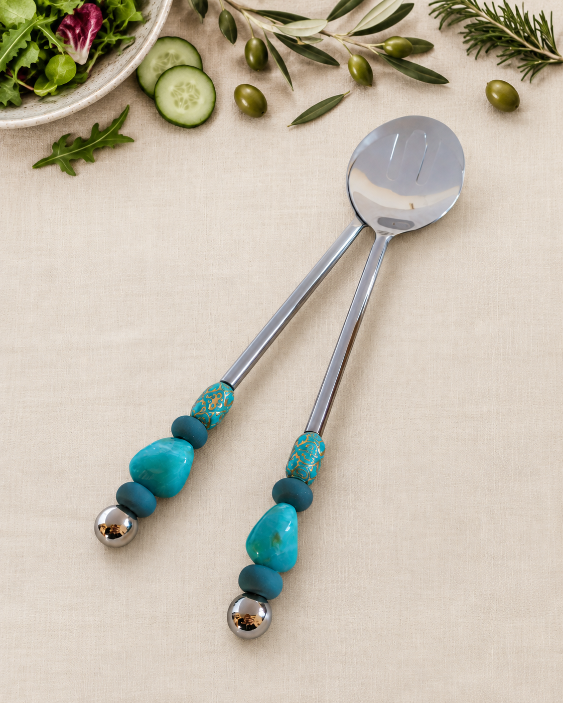The Bijali decorative salad serving set with a silver-coloured spoon and slotted server, turquoise and blue beads, silver detailing and polished silver end beads.
