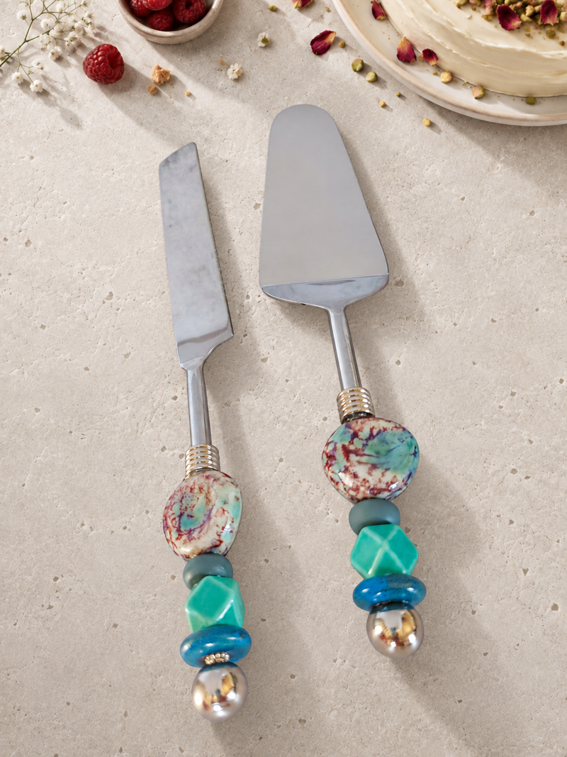 The Chariva cake serving set featuring a silver-coloured cake knife and cake server with multicoloured marbled beads, turquoise accents and polished silver end beads.