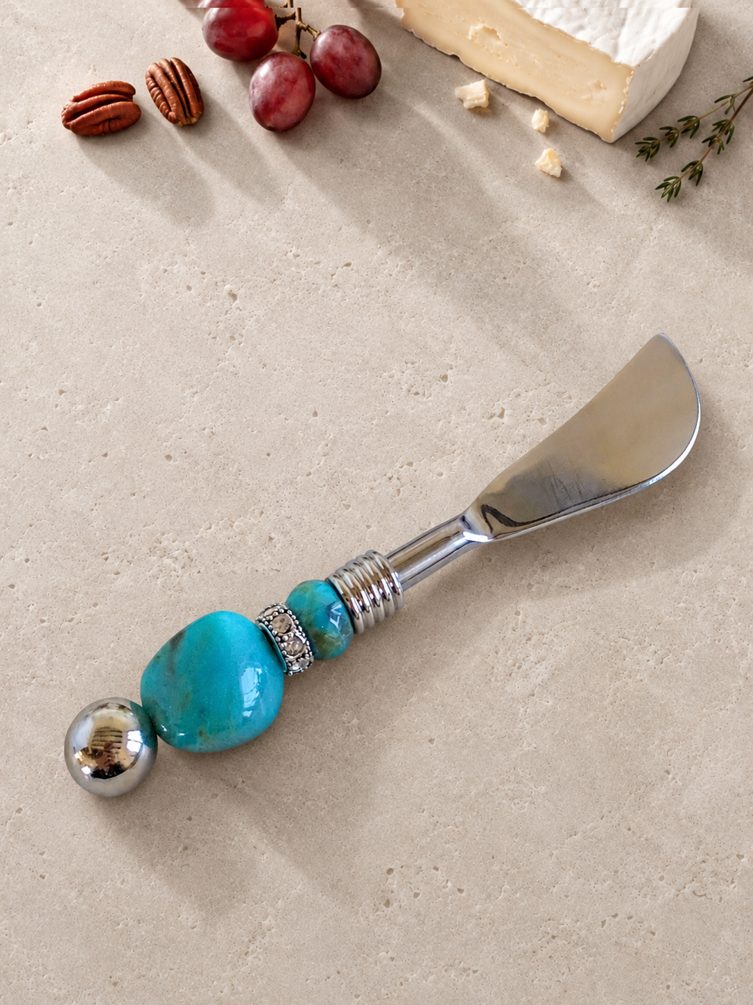 The Hidir butter knife featuring a silver blade, a large turquoise bead, a smaller turquoise accent bead and a polished silver end bead.