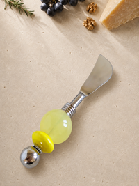  The Leylah butter knife featuring a silver blade, a large pale yellow bead, a smaller bright yellow bead and a polished silver end bead.