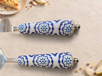The ASRI Cake Serving Set by Zapurah with blue and white patterned handles and silver finish