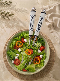 Salad serving spoon and fork with silver heads and white and black geometric handles from The Avani