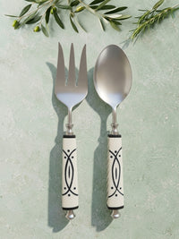 The Avani Salad Servers by Zapurah with white and black resin handles and silver finish