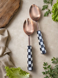 The Azara salad serving spoon and fork with rose gold heads and black and white checkered handles
