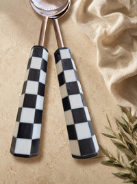 Detail of the black and white checkerboard handles on the Azara salad serving set