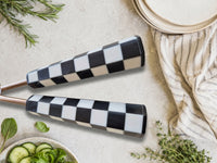Close up of the Azara salad spoon and fork with black and white checkered handles