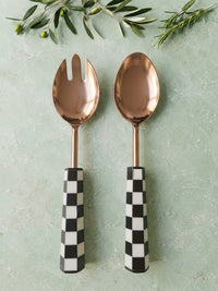 The Azara Salad Servers by Zapurah with black and white handles and rose-gold finish