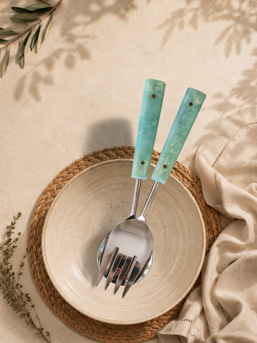 Salad serving spoon and fork with silver heads and jade green marbled resin handles from The Calia