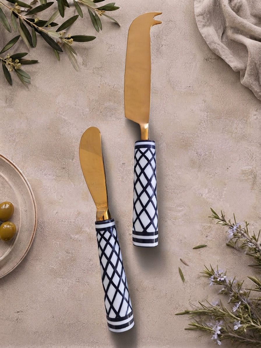 The Elara Cheese Knife Set by Zapurah with white and black resin handles and gold finish