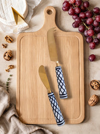 Gold cheese knives with black and white patterned handles, the Elara cheese knife set