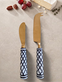 Cheese knives with gold heads and black and white geometric handles from The Elara