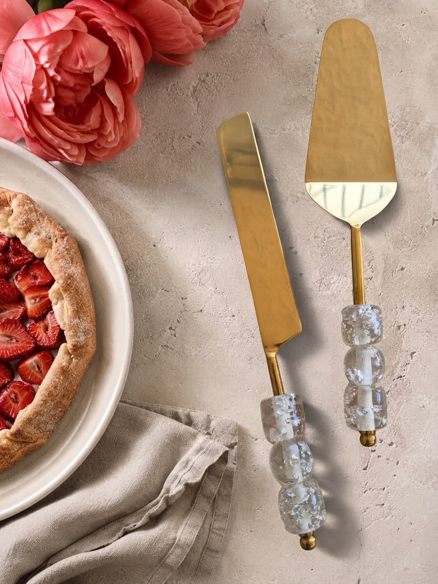 The Embun cake serving set with gold finish and transparent beaded handles