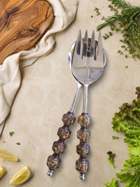 The Kalina salad serving set with silver heads and faceted smoky brown beaded handles