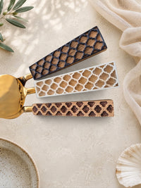 Detail of the brown, ivory and dark brown patterned handles on The Kartika cheese knife set