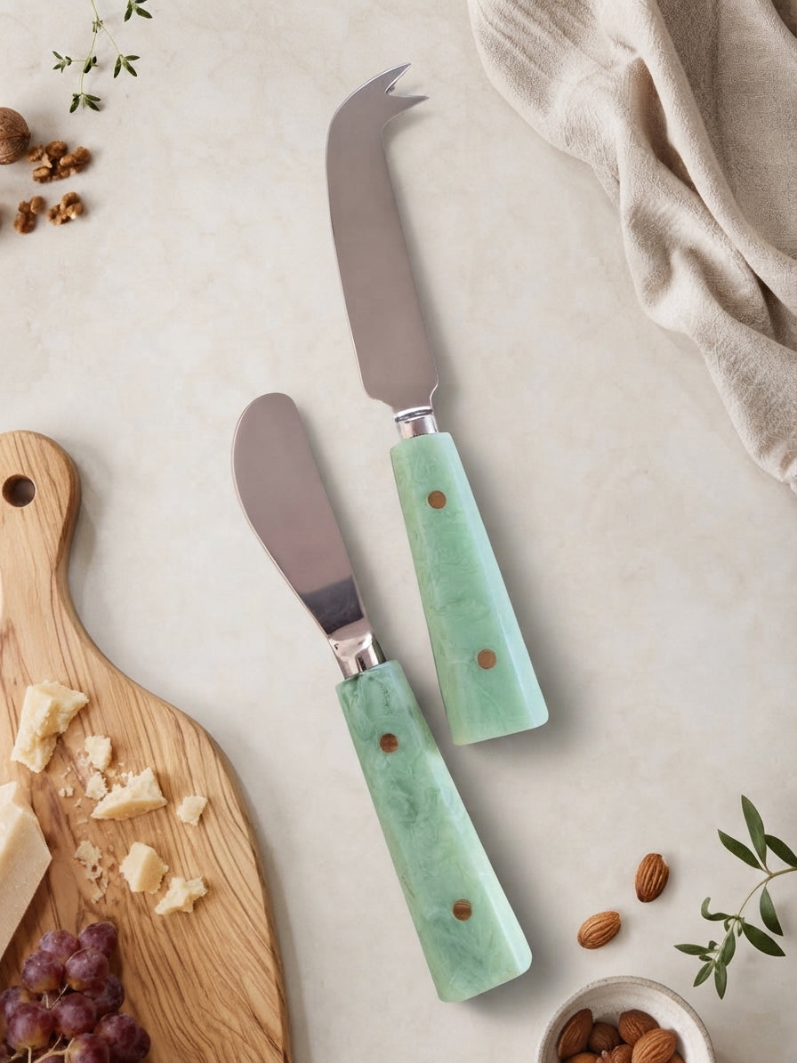 Cheese knives with silver heads and jade green marbled handles from The Maraya