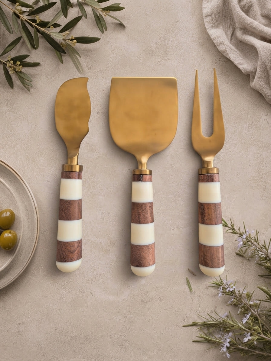The Nalaya cheese knife set with gold metalwork and brown and ivory banded handles