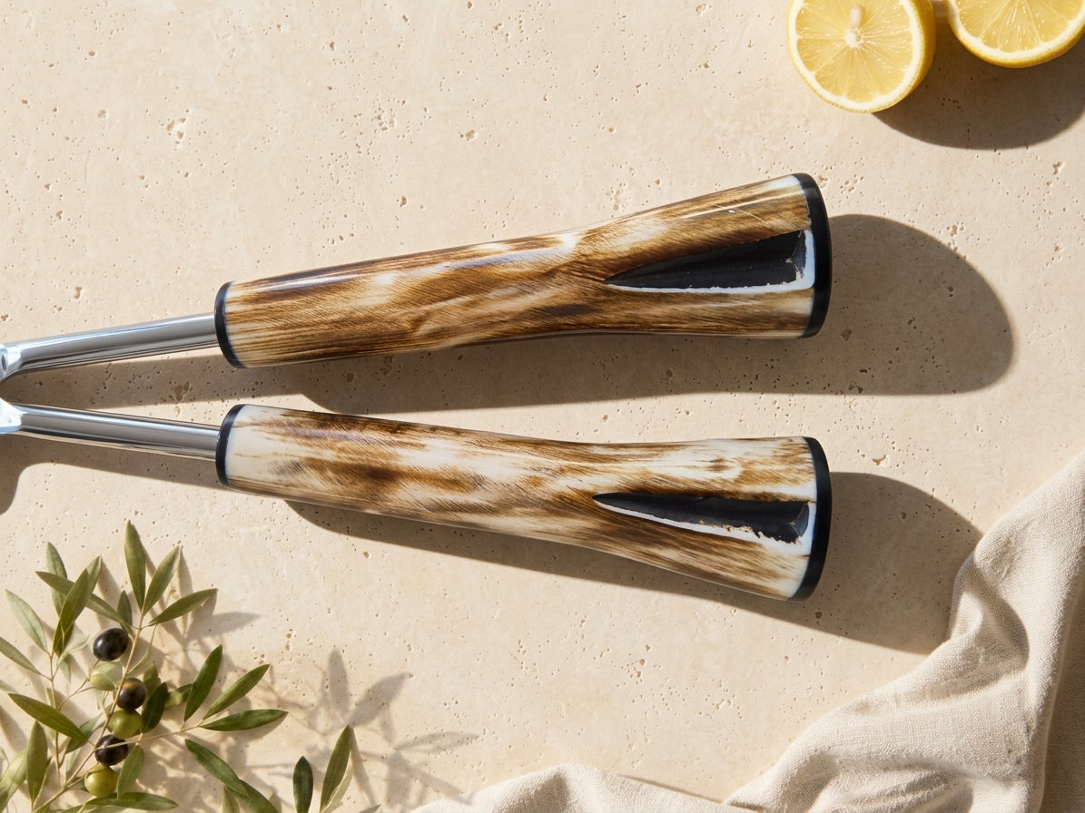 Close up of the Nalira salad spoon and fork with silver heads and marbled handles