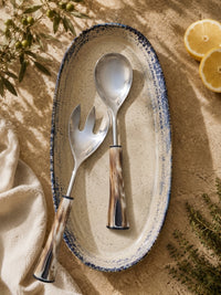 The Nalira salad spoon and fork with silver heads and natural marbled handles