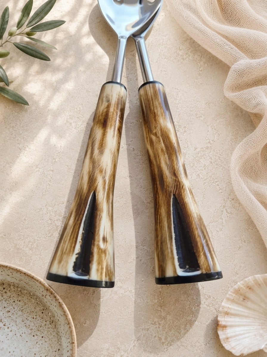 The Nalira serving set with silver finish and brown and cream patterned handles