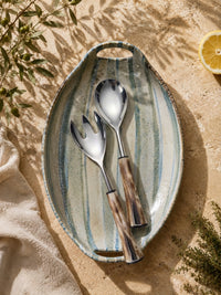 The Nalira salad serving spoon and fork with silver heads and marbled brown and cream handles