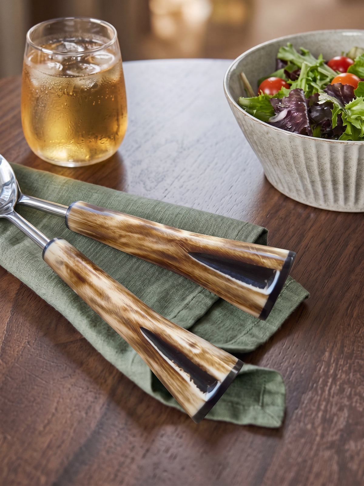 Detail of the marbled brown and cream handles on the Nalira salad serving set