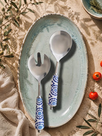 Salad serving spoon and fork with silver heads and blue and white patterned handles from The Ravina