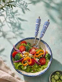 The Ravina salad spoon and fork with silver heads and blue and white ceramic style handles
