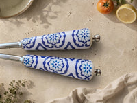 Detail of the blue and white patterned handles on The Ravina salad serving set