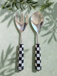 The Talisa Salad Servers by Zapurah with black and white checkerboard resin handles and silver finish