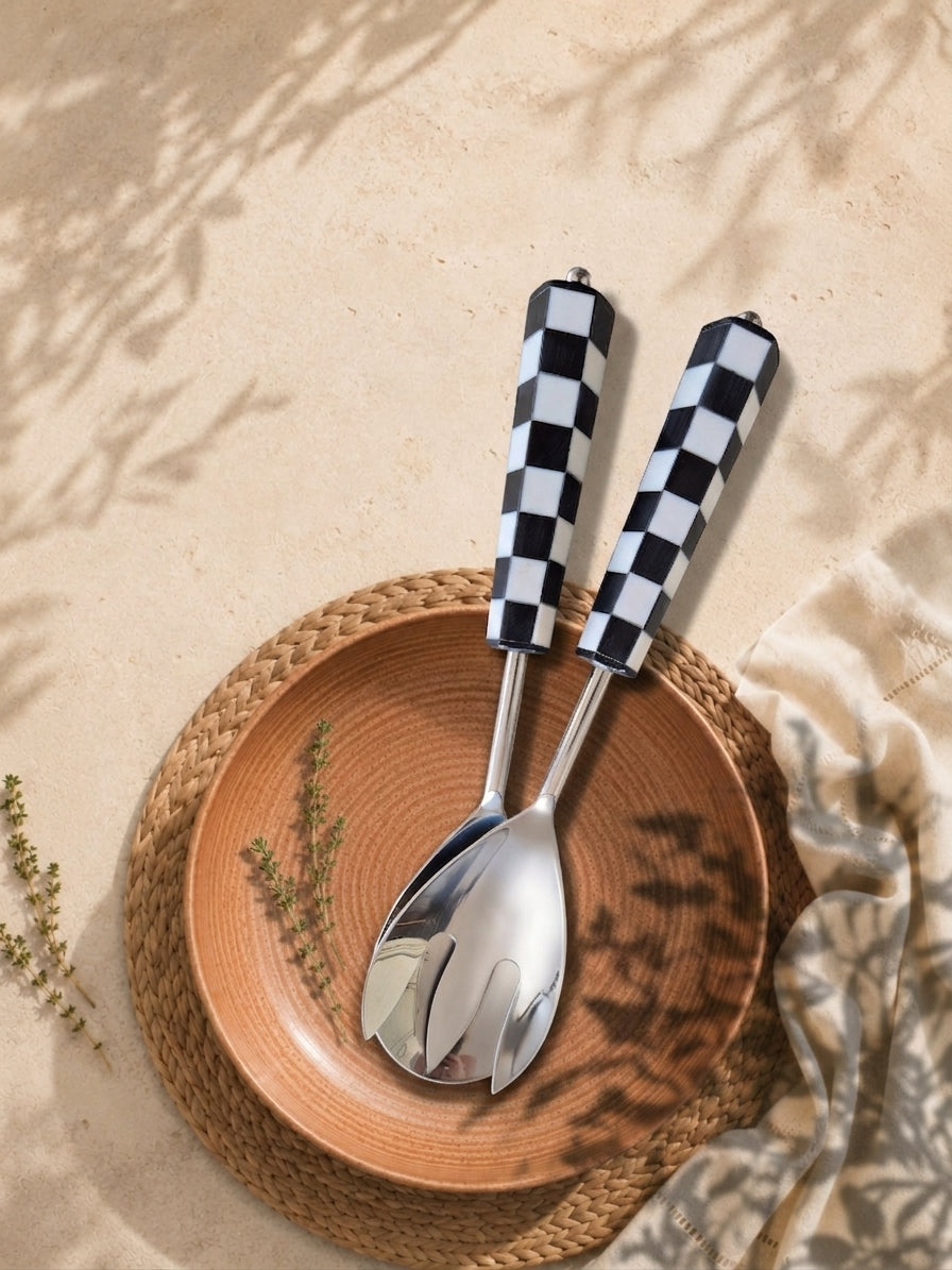 The Talisa salad serving spoon and fork with silver heads and black and white checkerboard resin handles