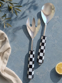 The Talisa salad serving spoon and fork with silver heads and black and white checkerboard resin handles