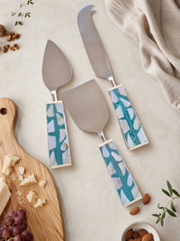The Teratai cheese knife set with silver heads and turquoise, white and beige mosaic handles