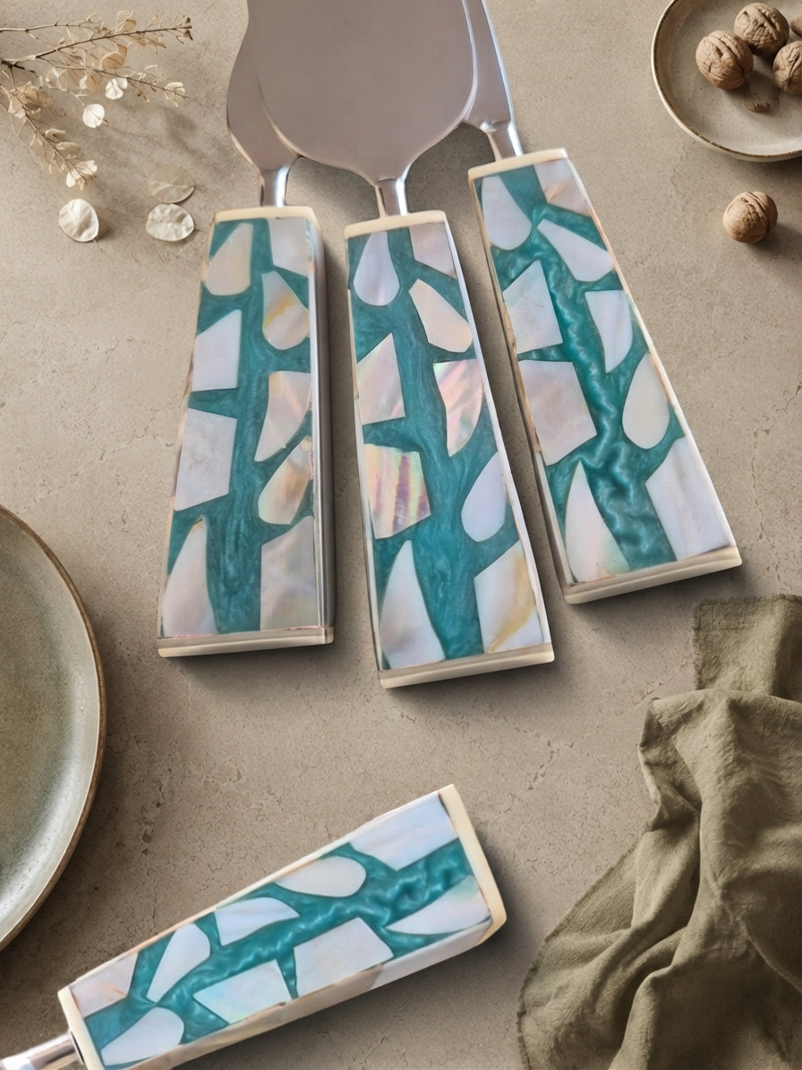 Three cheese knives with silver heads and turquoise, white and beige mosaic handles, The Teratai