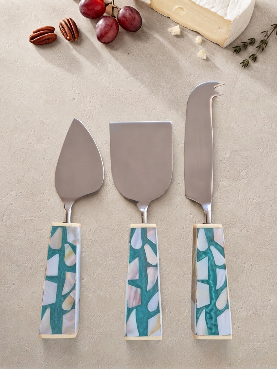 The Teratai Cheese Knife Set by Zapurah with turquoise mosaic-style handles and silver finish